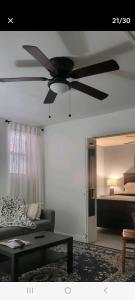 a living room with a ceiling fan and a bed at Private apartment, NOT SHARED, Near public transportation, SUPER fast free WIFI, Due to NY restrictions it can only be booked for 30 nights or more, even if the site allows you to book it, I WILL NOT be able to accept the reservation, 30 NIGHTS MINIMUM in Hunts Point