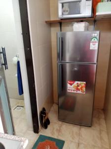 a kitchen with a stainless steel refrigerator in a room at Runda UN Gigiri - kikao private cottage in Nairobi