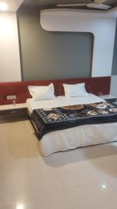 a bed in a room with two pillows at Hotel New Food Restrorent in Ujjain