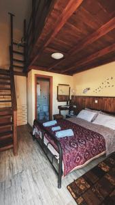 a bedroom with two beds and a wooden ceiling at Olympiades Rooms Litóchoro in Litochoro