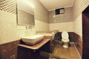 a bathroom with a sink and a toilet at EMINENCE - PALM RESIDENCY (1.5 KM FROM NAKKI LAKE) in Mount Ābu