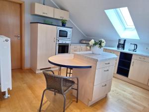 a kitchen with a small table and a table and chairs at Ferienwohnung Obertshauser in Nittenau