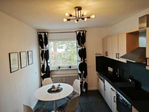 a kitchen with a table and a white table and chairs at 3 Zimmer Ferienwohnung 80qm in Bamberg