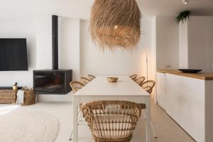 a dining room with a white table and chairs at Modern Retreat: 3 Bedroom Villa in the Old Village in Quarteira