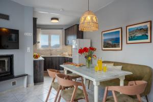 a kitchen and dining room with a table and chairs at House Aggeliki Private Hot Tub in Kissós +24 photos