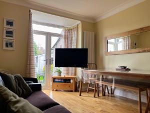 a living room with a flat screen tv and a couch at Luxurious 5 Bedroom Parking EV Great Location in Morecambe