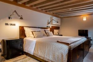 a bedroom with a large bed and a television at Ca' Pisani Hotel in Venice