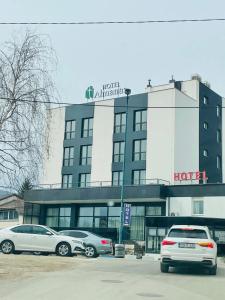 two cars parked in front of a hotel at Hotel Suljovic in Sarajevo