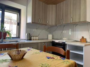 a kitchen with a table and a sink and a stove at Guesthouse Kroi City Center in Berat