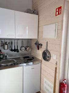 uma cozinha com armários brancos e utensílios na parede em Ugla Gistihús (Ugla Guesthouse) em Hella