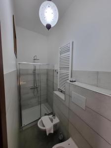 a bathroom with a toilet and a clock on the wall at Borgo Scorciarini B&B in Piedimonte Matese