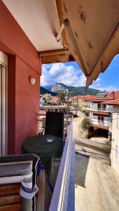 a balcony with a table and a view of a mountain at Olympiades Rooms Litóchoro in Litochoro