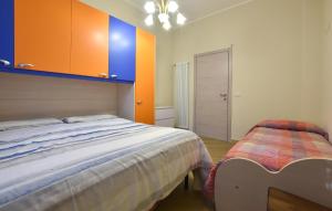 a bedroom with a bed and orange and blue cabinets at Lovely Home In Linguaglossa With Wifi in Linguaglossa