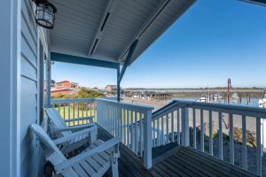 a porch with two chairs and a view of the ocean at Bandon Marina Inn in Bandon