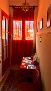 a room with a table and a red curtain at Olympiades Rooms Litóchoro in Litochoro