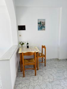 una mesa de comedor y sillas en una habitación en PROFILIO Apartments & Studios, en Exopoli