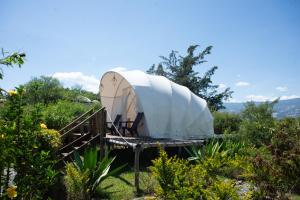 a dome tent on a stand in a garden at Origen Glamping en Villa de Leyva in Villa de Leyva