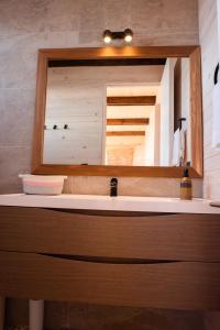 a bathroom with a sink and a mirror at Espectacular Casa Palafito frente al mar in Pichilemu