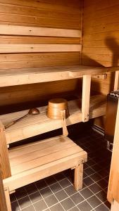 a wooden sauna with a hat sitting on the shelf at Arctica in Saariselka