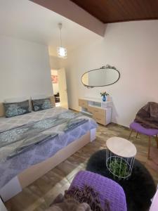 ein Schlafzimmer mit einem großen Bett und einem Spiegel in der Unterkunft Къща за гости Casa Per Te in Marchevo