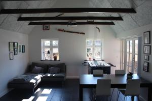 a living room with a couch and a table at Wonderful house & garden in Tommerup