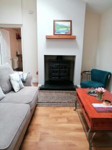 a living room with a couch and a fireplace at The Beeches in Newry