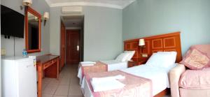 a hotel room with two beds and a kitchen at Grand Nar Hotel Adults Only in Kemer