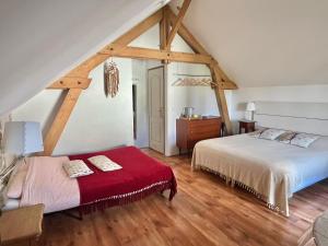 Monthou-sur-CherにあるChambres d'Hôtes La Vallée des Vignesのベッドルーム1室(ベッド2台、赤毛布付)