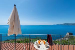 a table with two teddy bears on top of a balcony with the ocean at CASA OLGA, UN AFFACCIO SUL MARE !! in Praiano