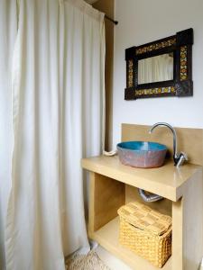 a bathroom with a sink and a shower curtain at Casa EL ORIGEN in Tandil