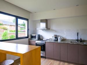 a kitchen with a stove and a counter top at Casa EL ORIGEN in Tandil