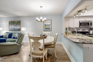 a kitchen and dining room with a table and chairs at Seawinds Oceanfront Condo in St. Augustine