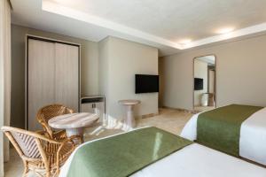Ένα ή περισσότερα κρεβάτια σε δωμάτιο στο Oz Hotel Cartagena