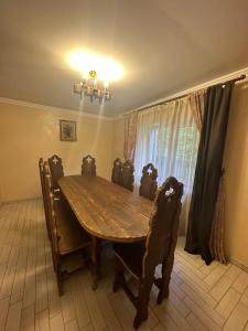a dining room with a wooden table and chairs at Писанка in Yaremche +19 photos