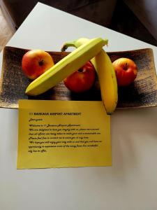 a card with a banana and apples on a table at 11 Baneasa Airport Apartament in Bucharest