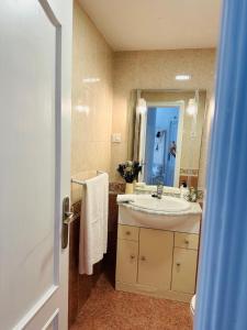 a bathroom with a sink and a mirror at Charming & cosy beach apartment in Torremolinos