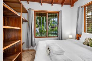 a bedroom with a bed and a large window at Hotel Bahia Esmeralda in Potrero