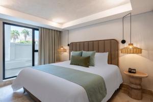 Ένα ή περισσότερα κρεβάτια σε δωμάτιο στο Oz Hotel Cartagena