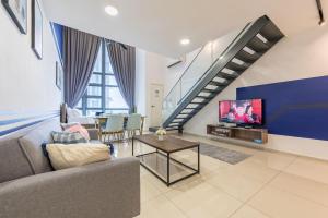a living room with a couch and a tv at Ekocheras Cozy Loft in Kuala Lumpur
