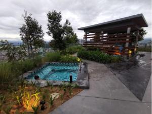 a swimming pool in front of a building at Ekocheras Cozy Loft in Kuala Lumpur