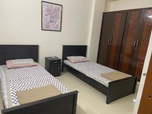 two twin beds in a room with at Dpinn homestay in Hyderabad