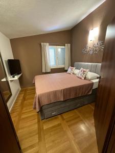 a small bedroom with a bed and a television at Apartment Pupina in Žrnovnica