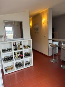 a room with a shelf with bottles of wine at Apartment Pupina in Žrnovnica