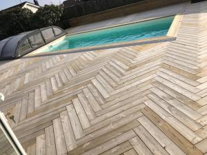 a swimming pool on the side of a house at Stan- och strandnära poolvilla. in Halmstad
