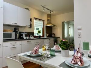 a kitchen with a table with plates of food on it at 2-Zi. Apartment 42 qm, an der Friedrichsau/Messe in Neu Ulm +5 photos