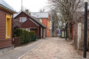 a cobblestone street in a town with houses at City Center Apartment with balcony in Anykščiai