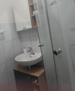 a bathroom with a sink and a glass shower door at Matteo in Supetarska Draga +49 photos
