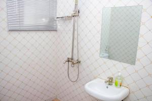 a bathroom with a shower and a sink at Cozy Urban Oasis 3 Bedroom in Ogba, Ikeja, Lagos in Egba