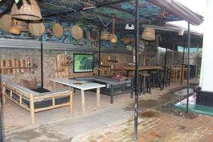 a restaurant with a table and some chairs and tables at Room in BB - Amahoro Guest House - Queen Room in Ruhengeri