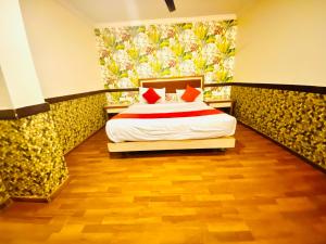 a bedroom with a bed and a painting on the wall at The City Park hotel in Hyderabad